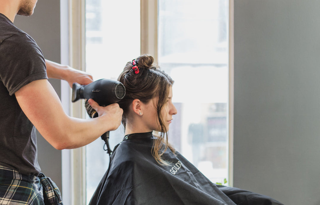 woman blow drying hair