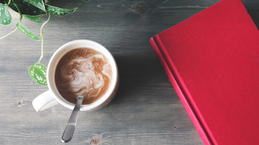 red travel journal and coffee