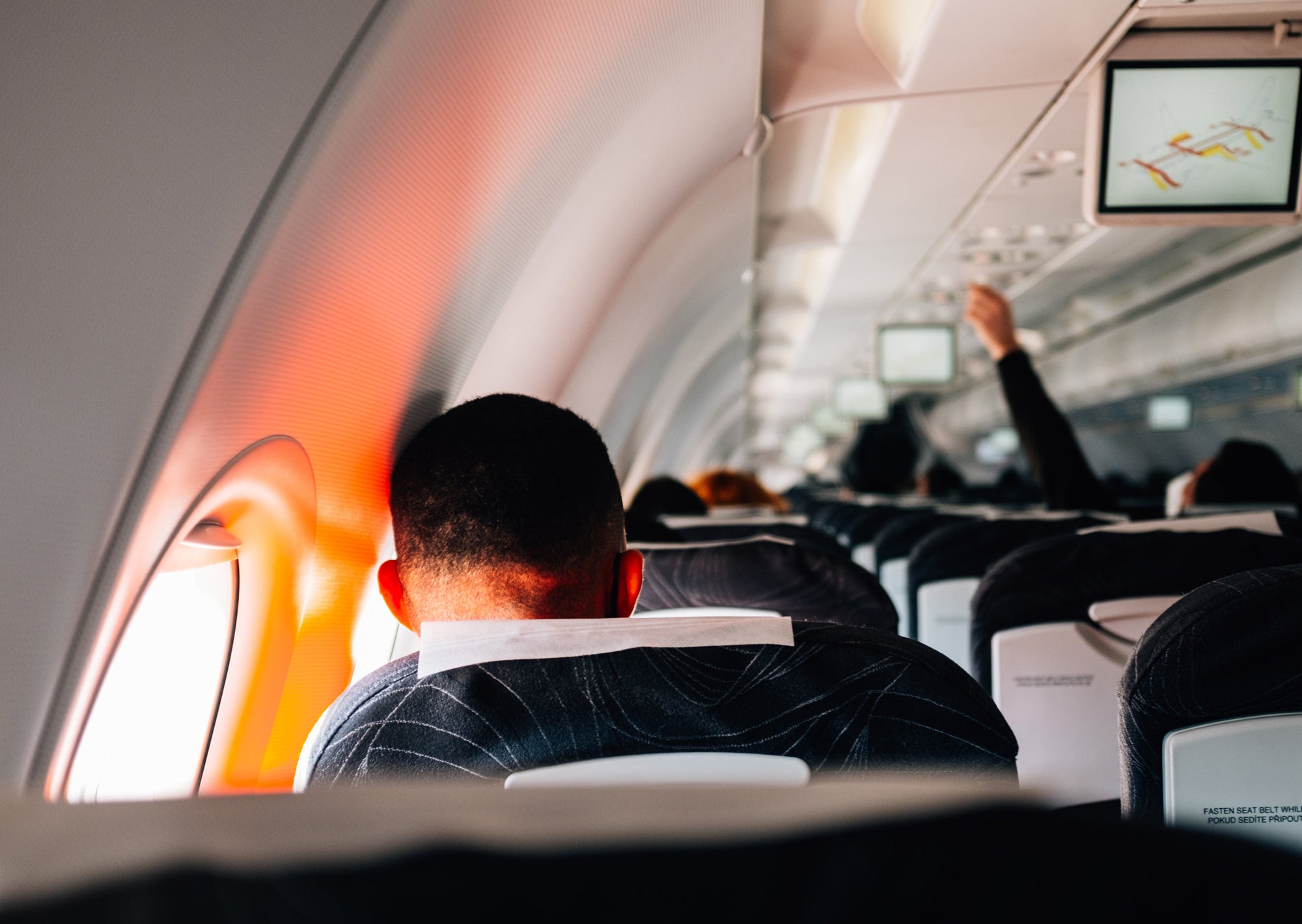 man wearing komfort kollar on airplane