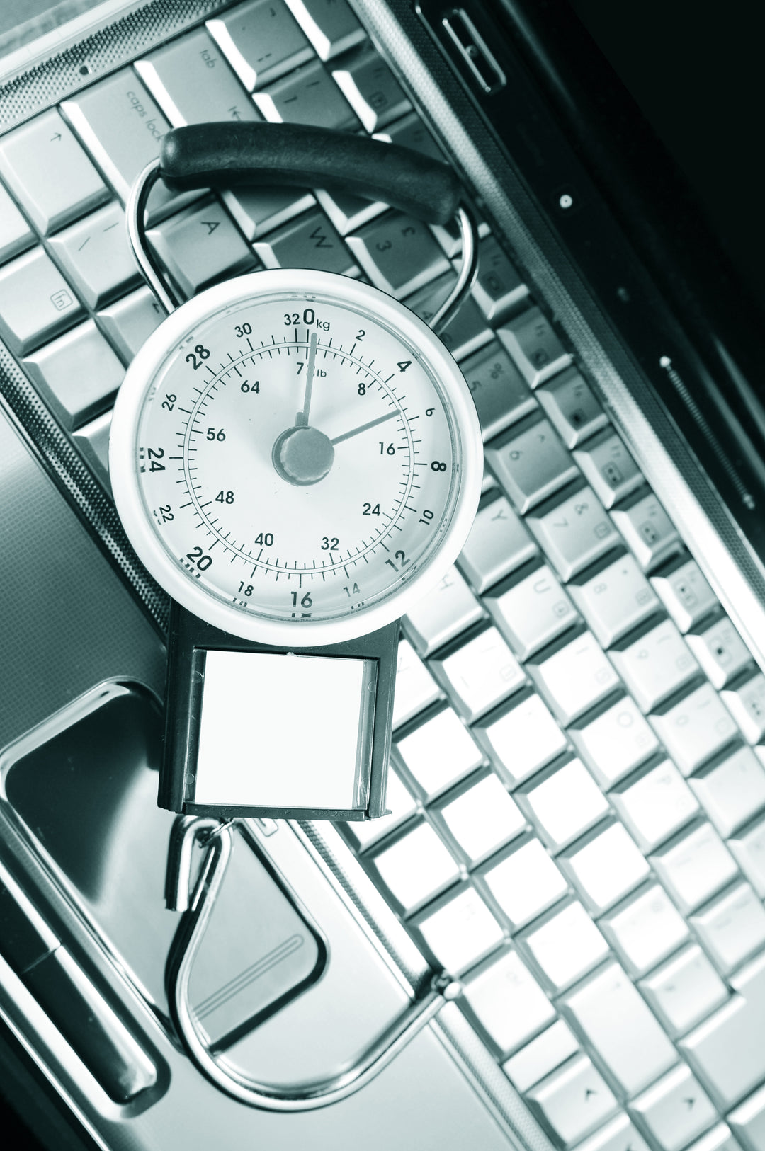 silver luggage scale on laptop