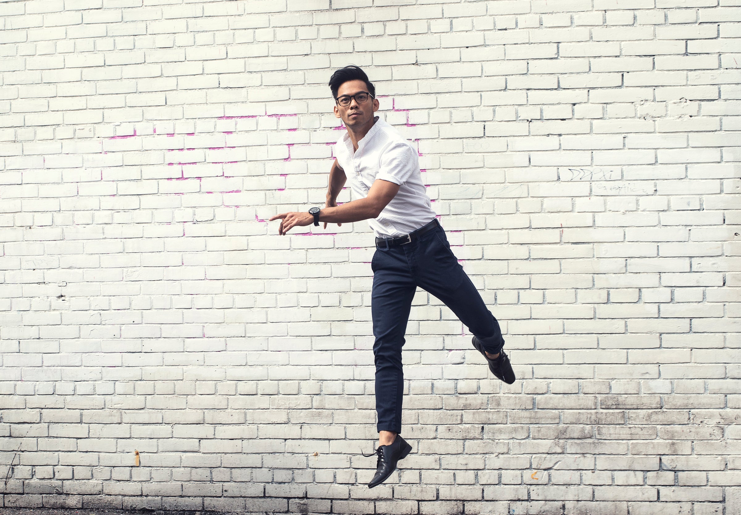 man jumping while wearing white wrinkle free travel shirt