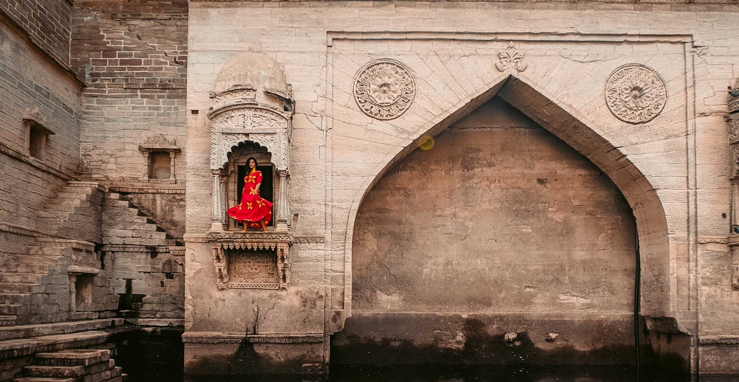 Woman in red dress traveling India