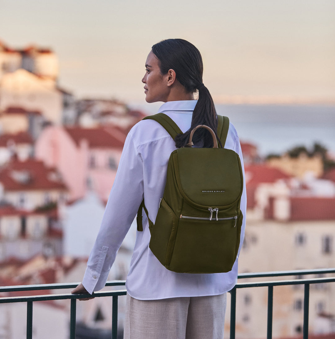 Woman traveling europe with green briggs riley rhapsody backpack