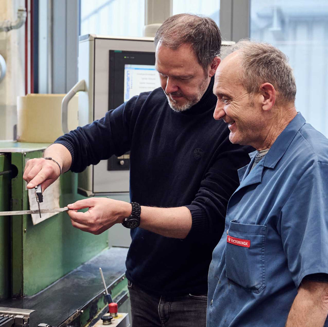 Two men desiging swiss army knife