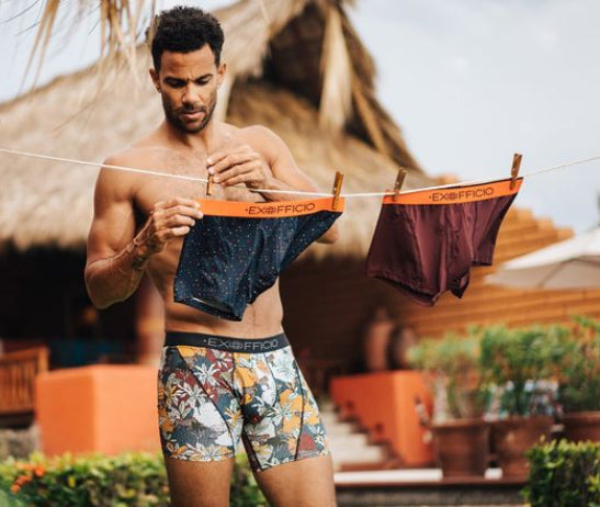 man hanging up his travel underwear to dry in Hawaii