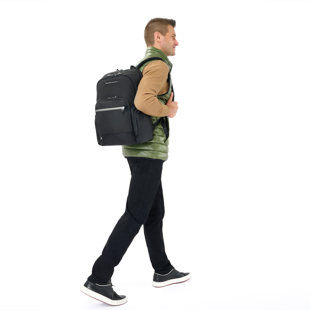 Man carries Medium Cargo backpack in color black