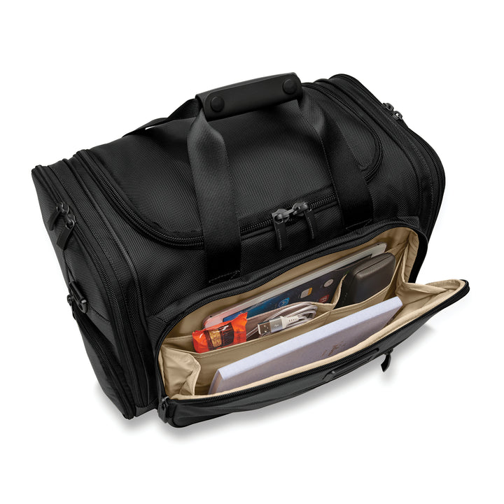 Front pocket of Briggs & Riley Baseline Underseat Duffle has candy bar, charger, notebook and ipad