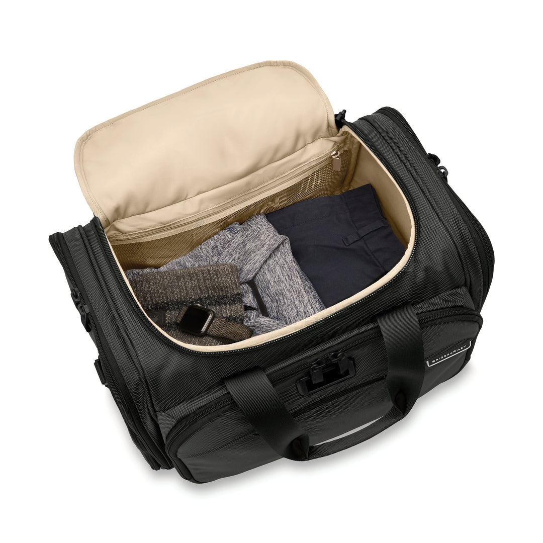 Interior of Briggs & Riley Baseline Underseat Duffle packed with hat pants and shirt