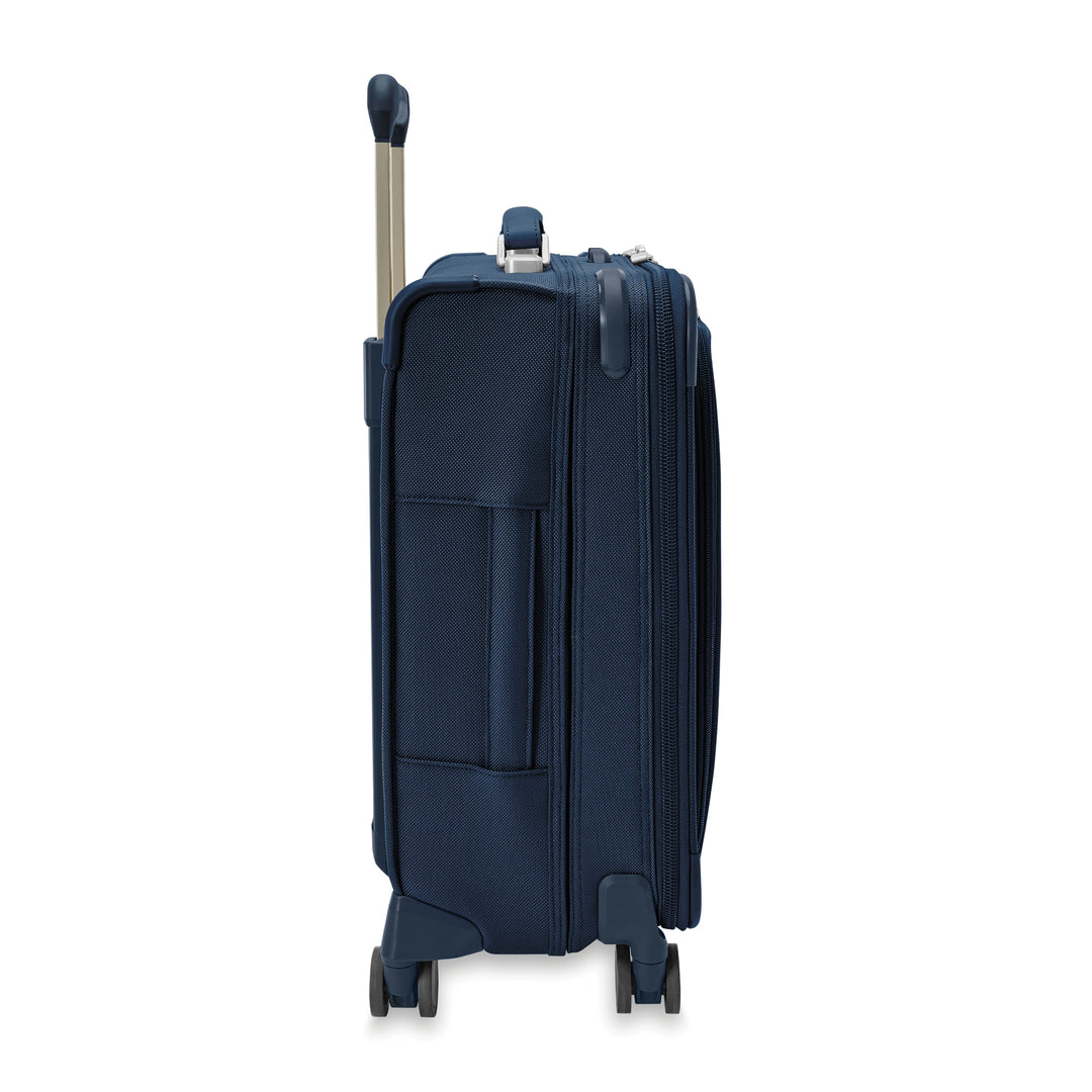 Side view of global carry on spinner in navy blue has side handle