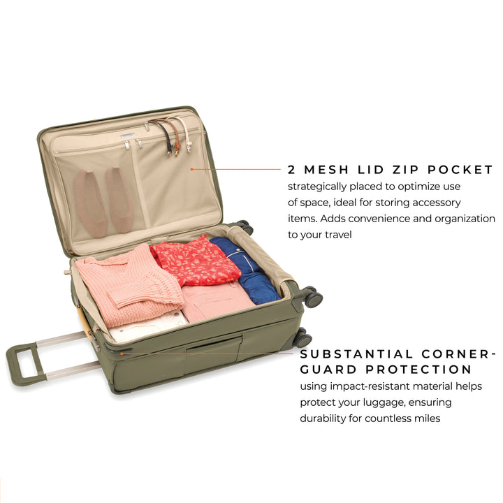 Interior of Medium expandable spinner suitcase packed with clothing and shoes