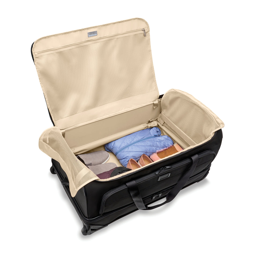 Inside of Large Duffel bag is lined with light tan lining for easily visibility of packed items such as shoes and jacket