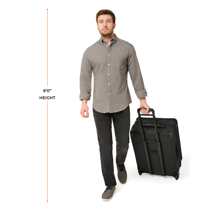 Man rolling Medium Expandable Upright suitcase