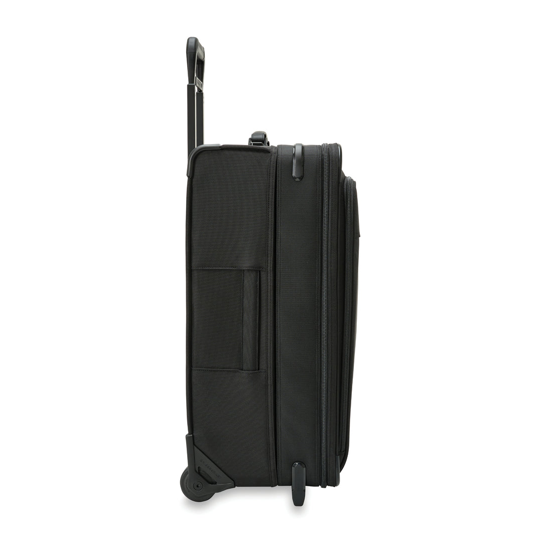 Side view of Medium expandable Upright suitcase showing wheels, wedged foot and handle