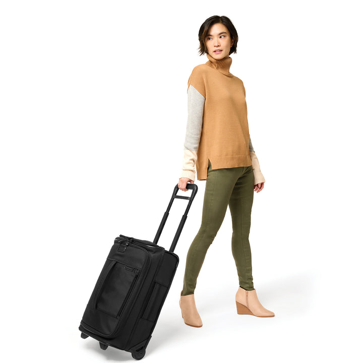 Female model is 5'8" and wheeling baseline global 2 wheel carry on duffle bag