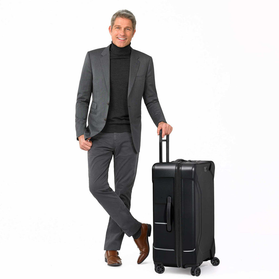 Male model with black torq hardside checked luggage