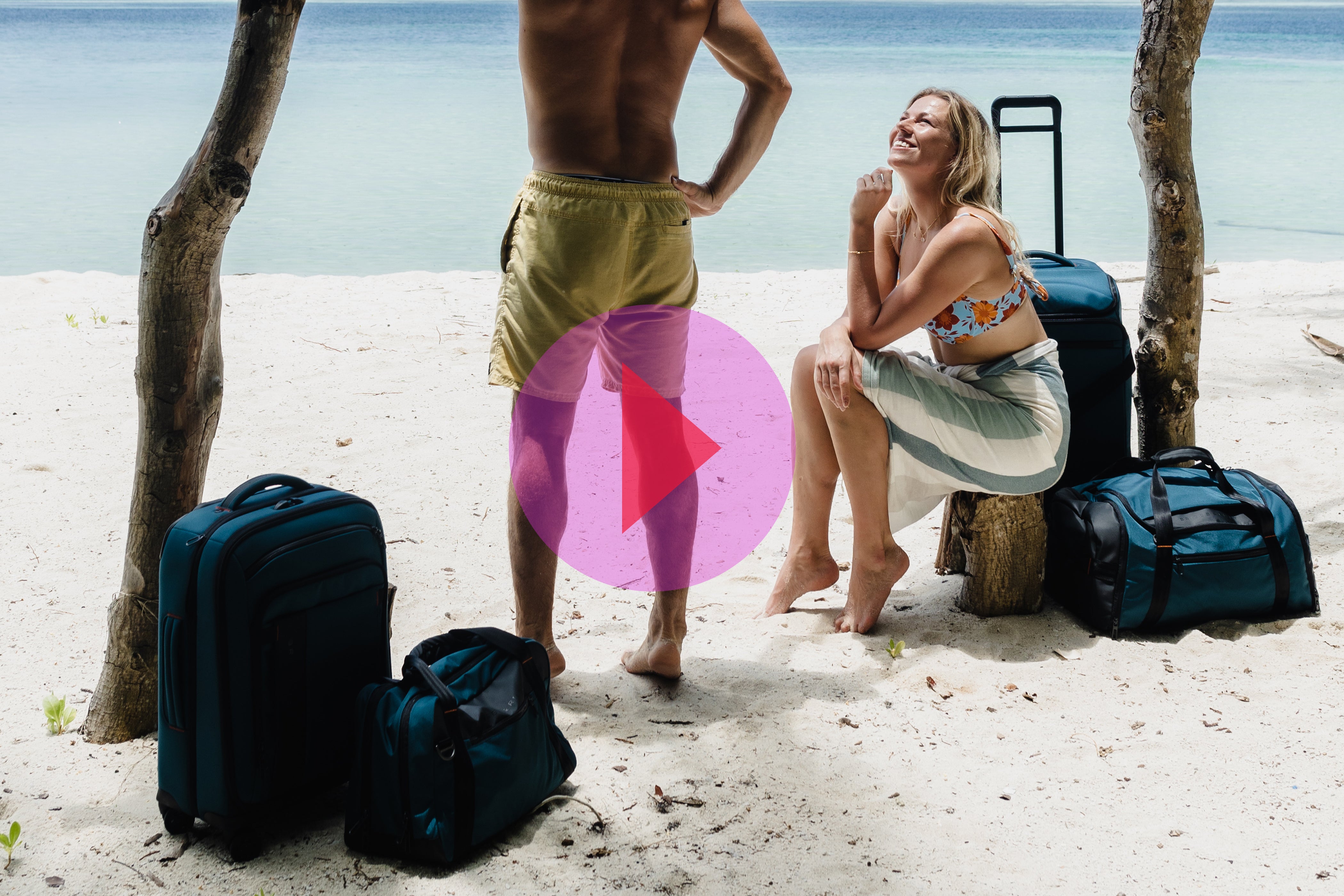 Man and Woman on beach with ZDX luggage