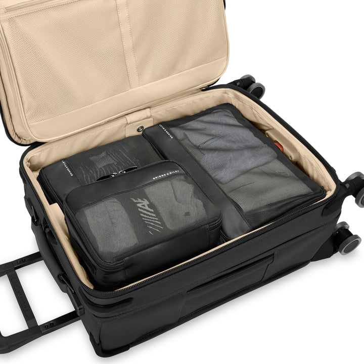 Black packing cubes packed inside luggage