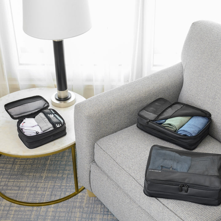 Three Packing cubes layed out on couch for trip