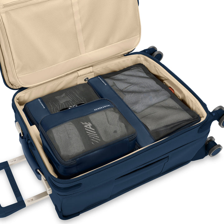 Navy packing cubes packed inside luggage