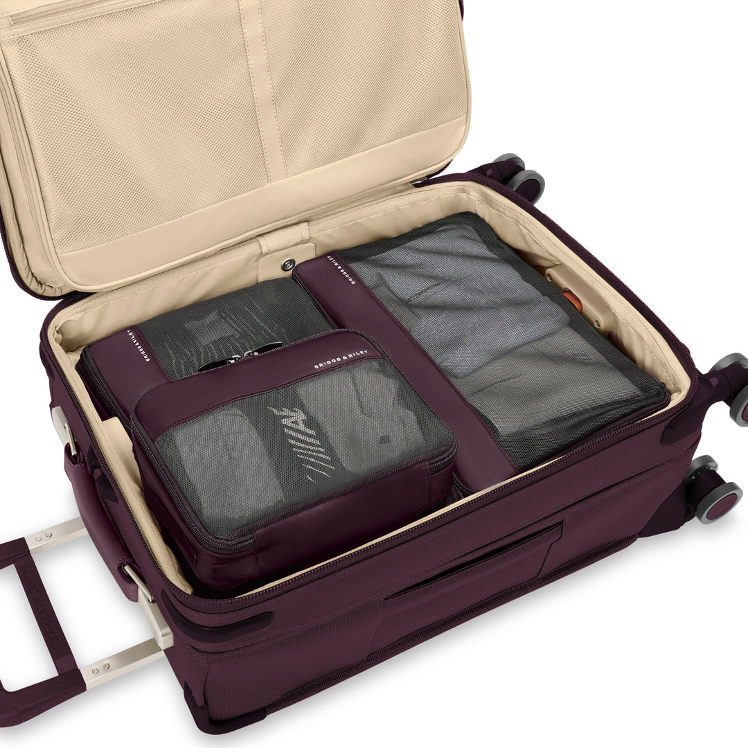 Plum Purple packing cubes packed inside luggage