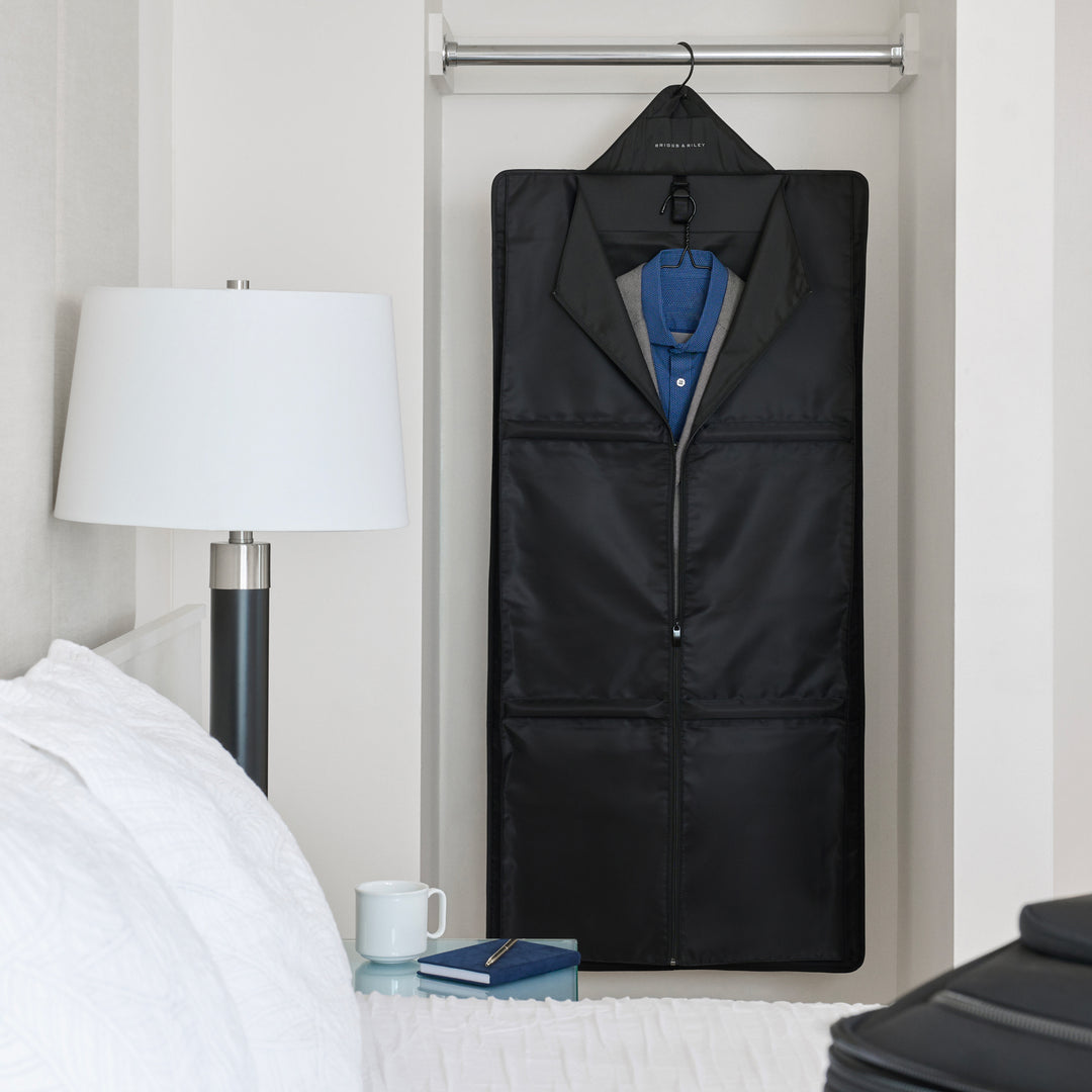 Garment sleeve hanging in hotel room on rack