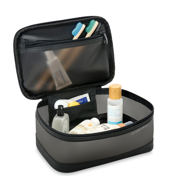 Translucent toiletry case packed with lotion and toothbrushes