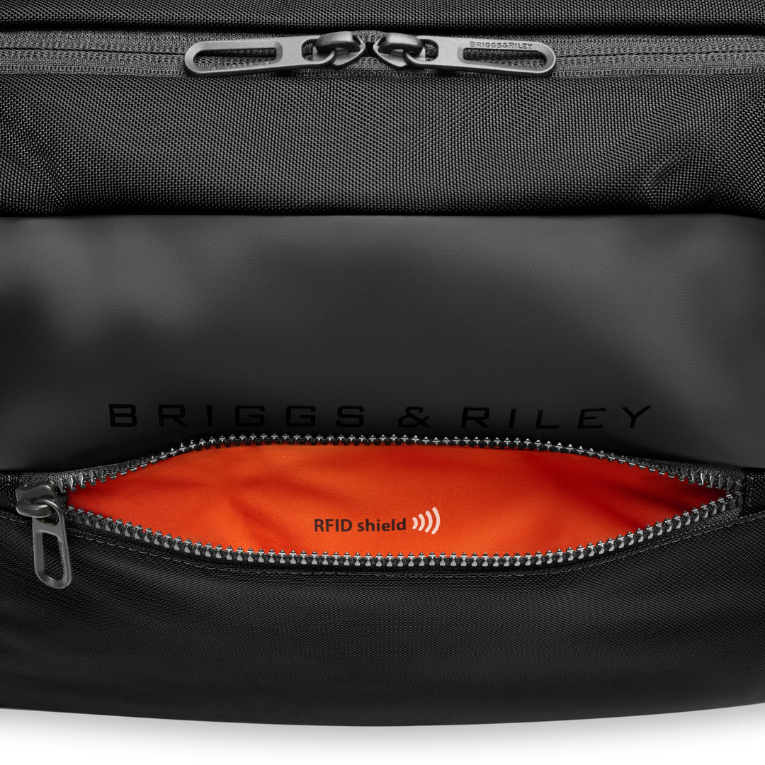 Close up of Speed Thru pocket with orange lining and RFID shield for passport and id Briggs & Riley ZDX Underseat Cabin Bag