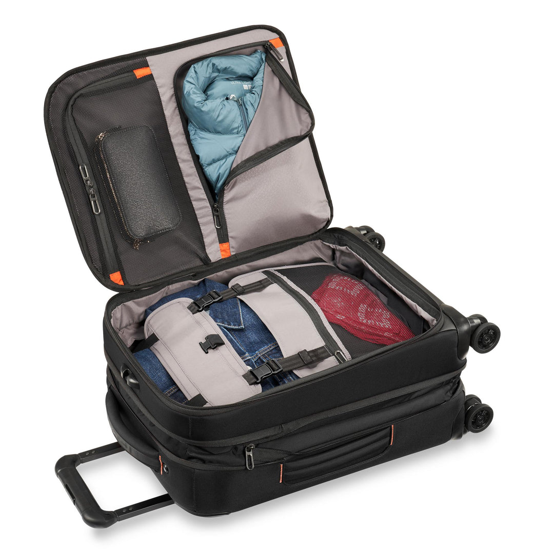 Briggs & Riley ZDX International 21" Carry-On Expandable Spinner packed with jean jacket, coat, and secured with panel