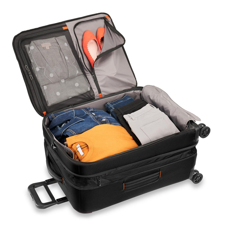 Interior packed with jeans jacket orange shirt pants and shoes Briggs & Riley ZDX Medium Expandable Spinner