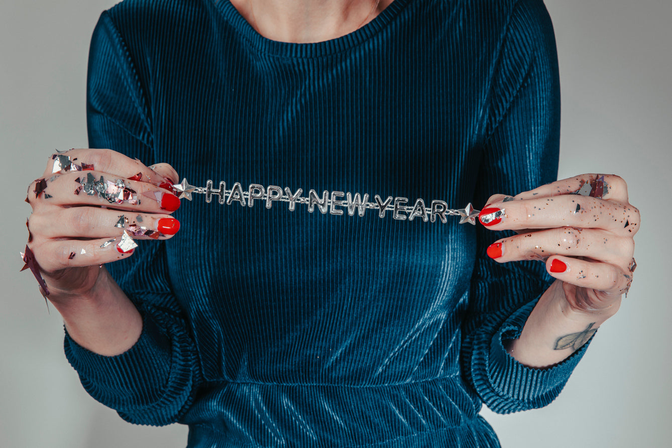 Woman holding happy new year sign