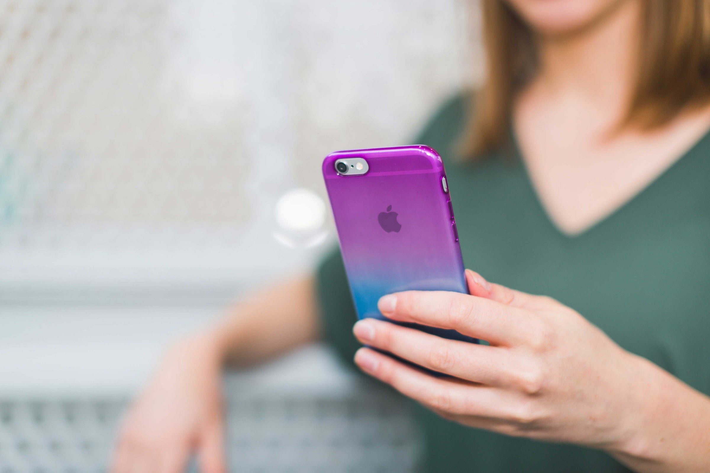 woman holding a purple iPhone