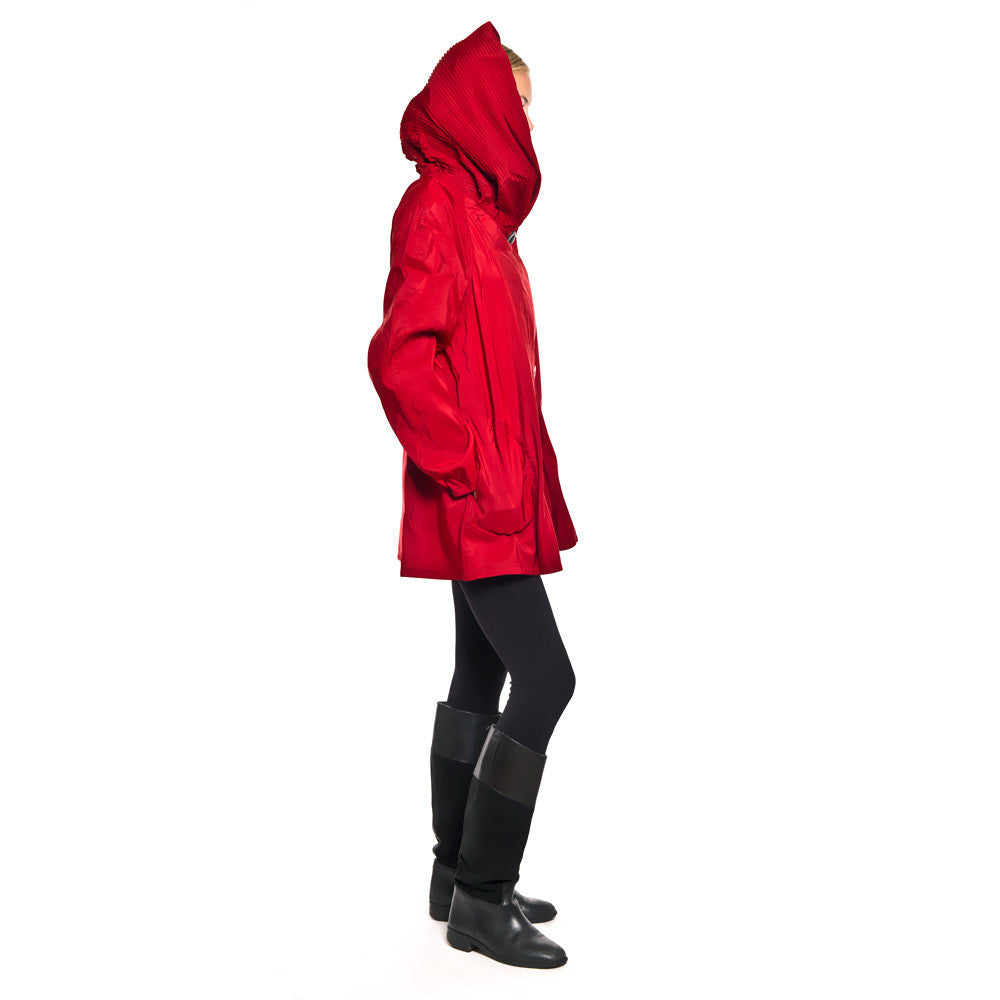 Side View of Red Mini Rain Jacket with Raglan Sleeves and Large Hood