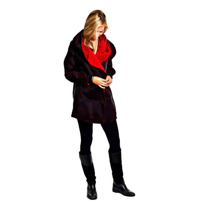 Woman buttoning Up Red Mini Rain Jacket Reveresed to Black with Red Collar